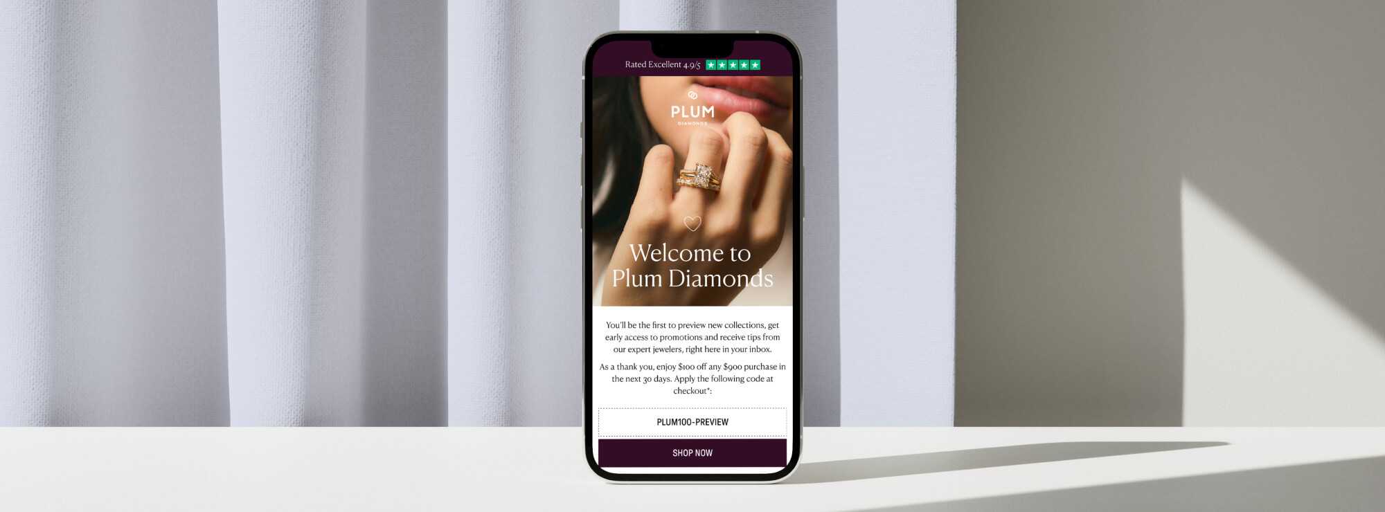 Plum Diamonds Welcome Email mock-up against blue curtains